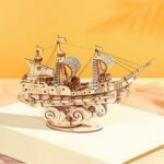 Un modèle en bois de puzzle 3D ROKR d'un bateau pirate perché au sommet d'un livre.
