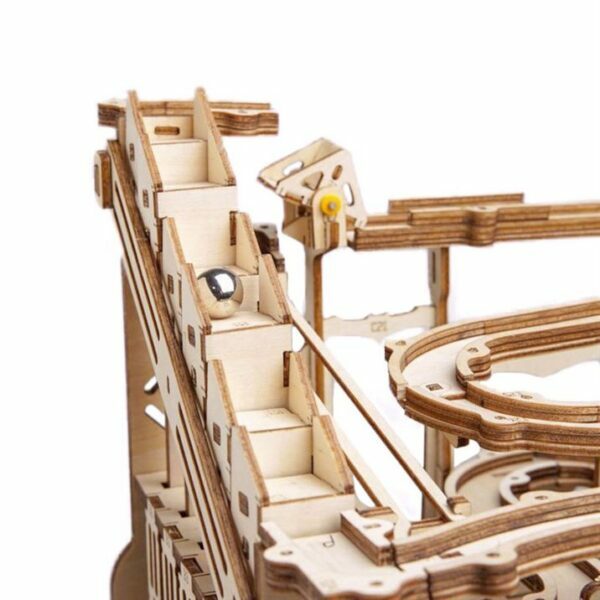 Un modÃ¨le de puzzle en bois 3d reprÃ©sentant des montagnes russes sur fond blanc.