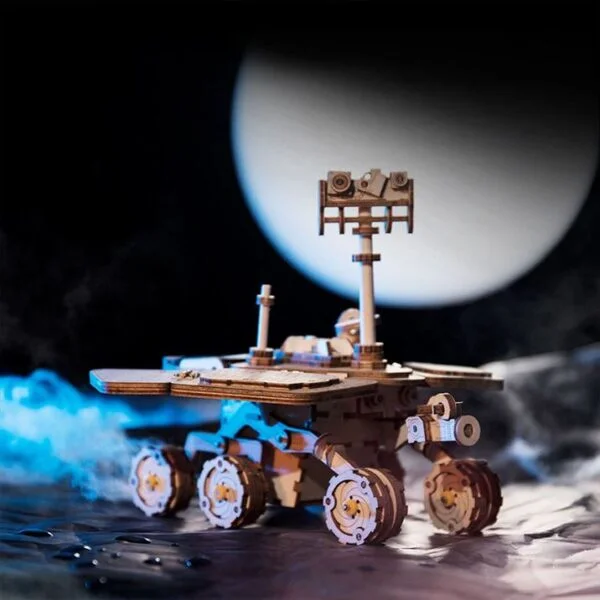 Une maquette d'un rover avec une lune en arriÃ¨re-plan.