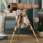 Une maquette de télescope en bois sur une table.