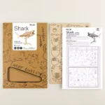 Une boîte à maquette avec un kit de découpe ROKR Puzzle 3D Requin et un dessin d'un requin.