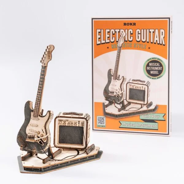 Une maquette 3d en bois d'une guitare électrique et amplificateur.