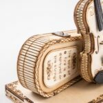 Un puzzle robotique 3D présentant une maquette de violon en bois sur une caisse en bois.